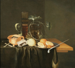 Still life on a table with smoking and drinking implements by Laurens Craen
