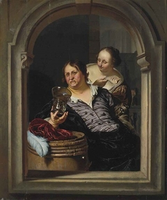 A Man Drinking and a Woman Offering Him a Fish