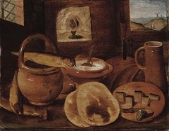 A poor man's meal, a loaf of bread, porridge, buns and a herring on a wooden table