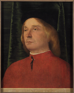 Portrait of a young man in red garment