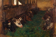 Young cattle enjoy green fodder in the barn