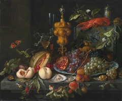 A still life upon a hard‐stone table in front of a stone wall