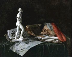 Still life with a stauette, drawings and a skull