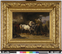 Interieur van een stal met paarden en een stalknecht by Wouterus Verschuur