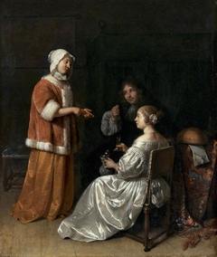 Interior with two young women in conversation and a man showing a coin