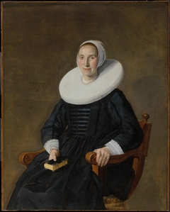 Portrait of a seated woman with a book by Jan Hals