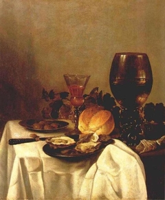 Still life with plates of oysters and olives, wineglasses and a bread roll by Anonymous