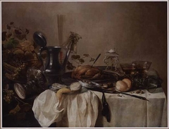 Still life with tazza, ewer, goblet, three roemers, roast fowl, grapes, bread, olives, walnuts and a lemon by Pieter Claesz