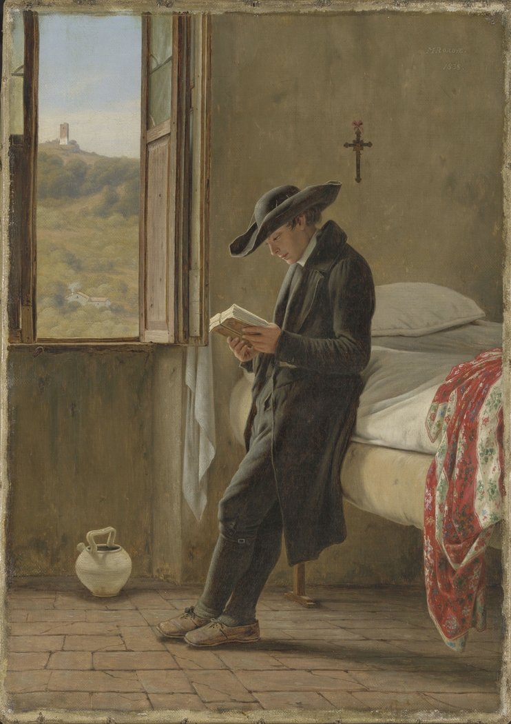 Young priest reading