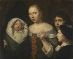 Portrait of a young woman with three children