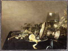 Still life with fruit and an overturned tazza before a roemer