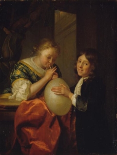 Boy and a Girl blowing a Pig's Bladder