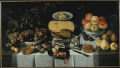 Still life of cheese and fruit on a laid table by Roelof Koets