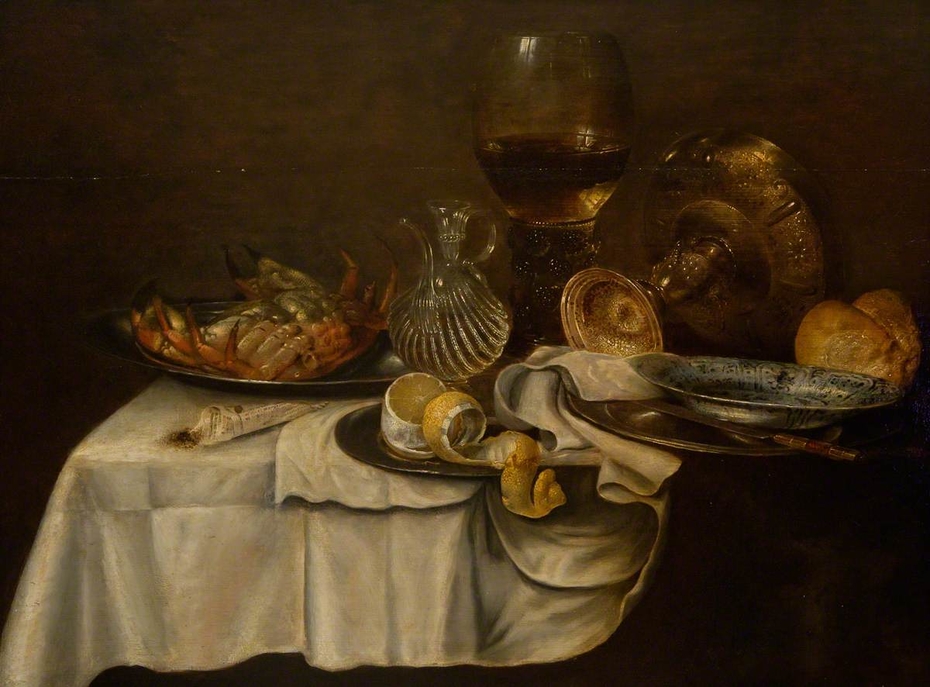 Still life with crab, bread, lemon, roemer, perfume bottle and pewter plates