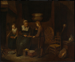 Interior with a woman baking pancakes and two children