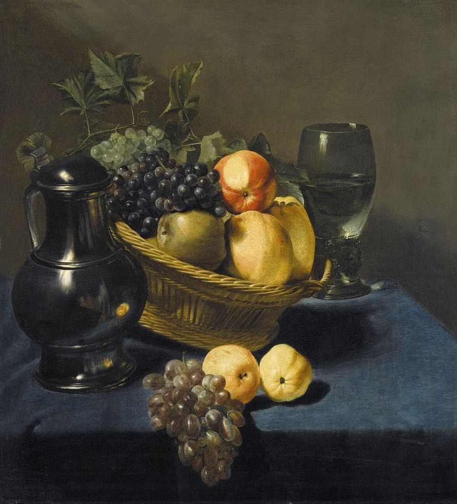 Still life with apples and grapes in a wicker basket on a table