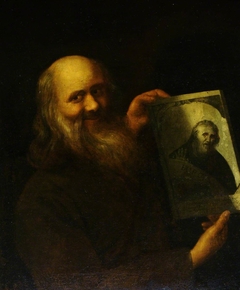 A Bearded Man holding up a Drawing