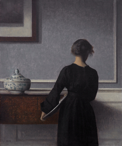 Interior with Young Woman Seen from the Back by Vilhelm Hammershøi