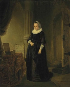 Portrait of a woman, standing full length in an interior