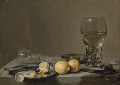 Still Life with Two Lemons, a Facon de Venise Glass, Roemer, Knife and Olives on a Table by Pieter Claesz