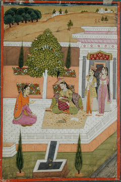 Two women seated on a terrace attended by two maids