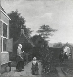 Woman with a glass of wine and a child in a garden