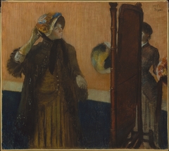 At the Milliner's by Edgar Degas