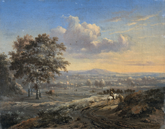 Hilly landscape with a rider on a country road
