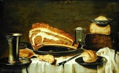 Still life of a laid table with cheese, meat and bread by Willem Kalf