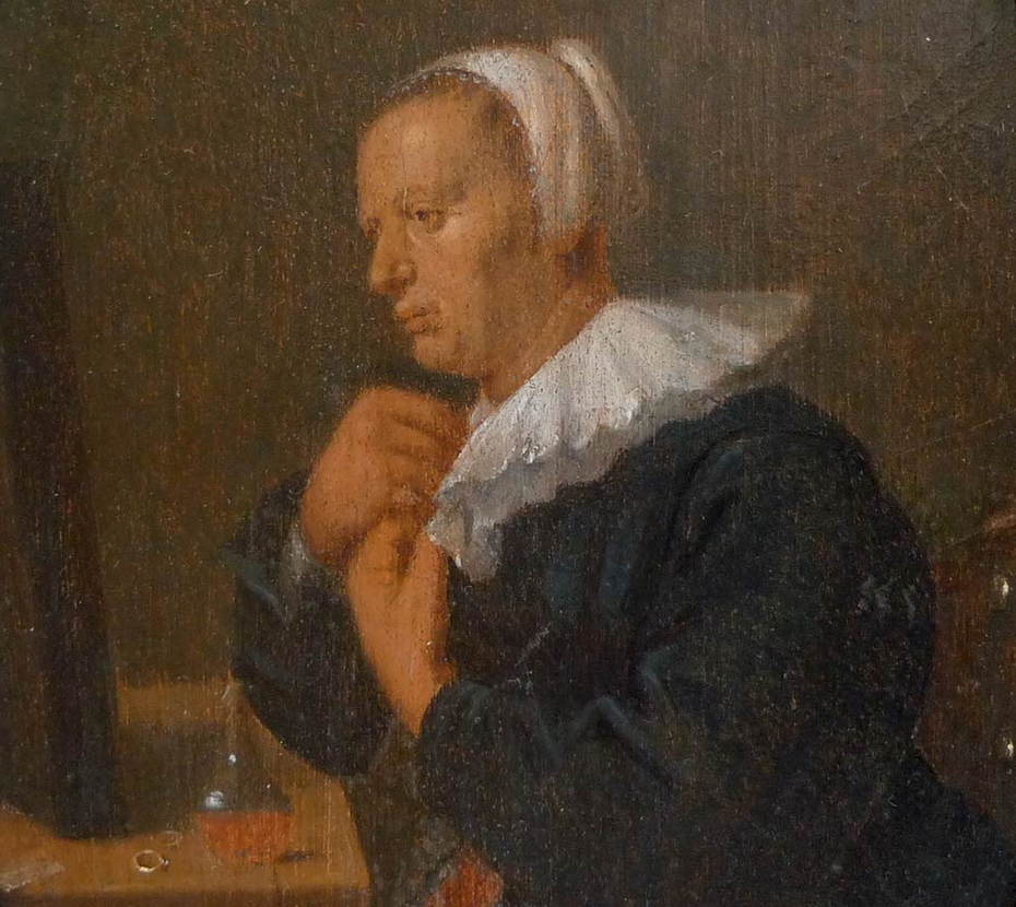Woman seated at a tabel before a mirror (Dressing up)